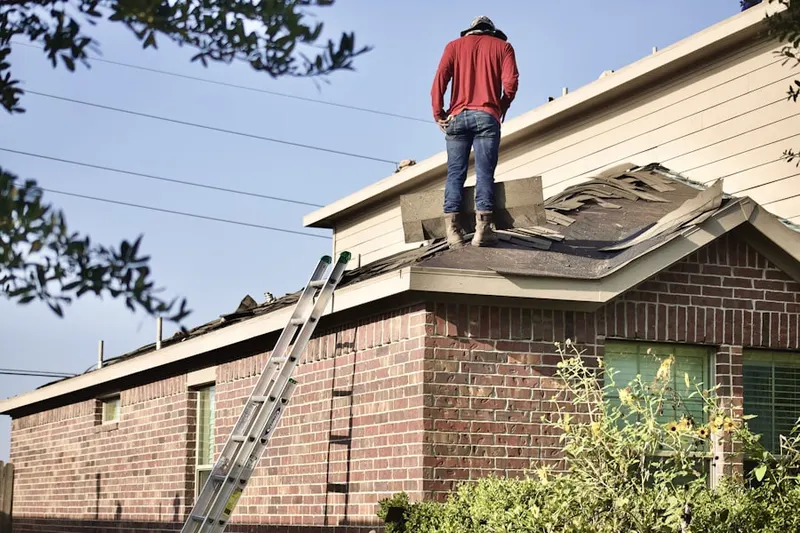 Professional roofer working on a residential roof in Mooseheart